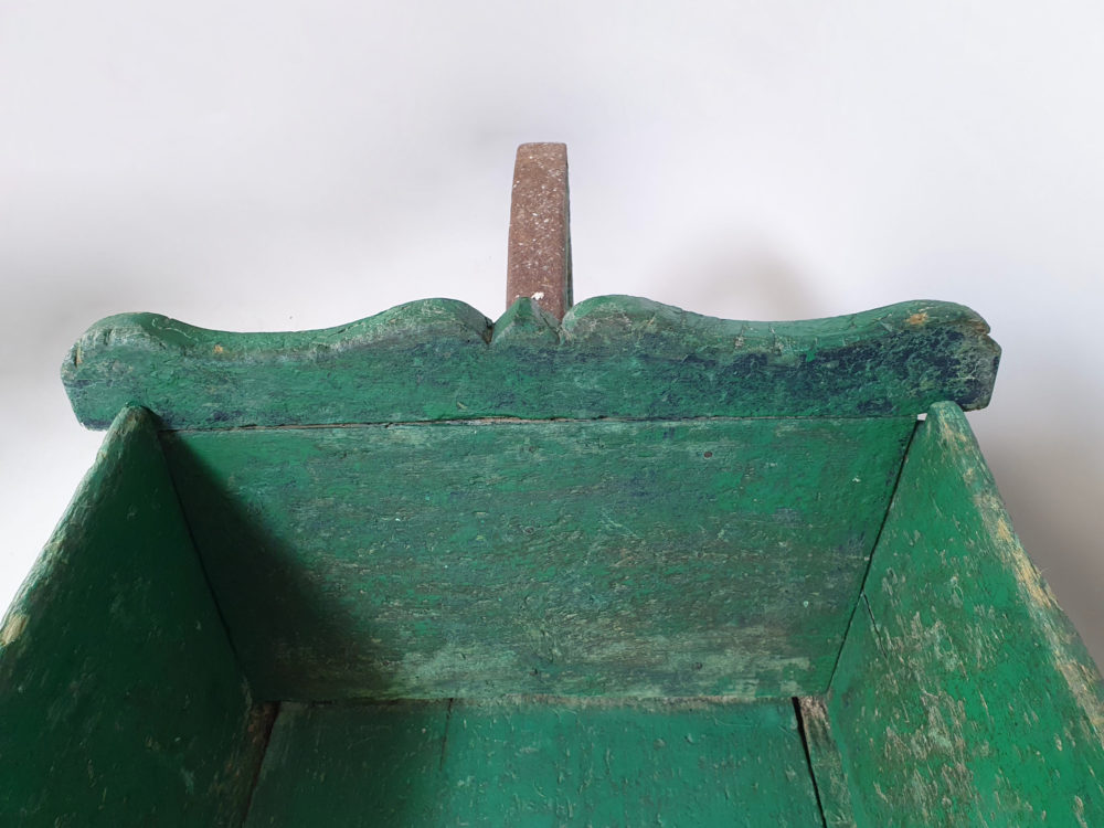 Antique garden wheelbarrow in original green paint