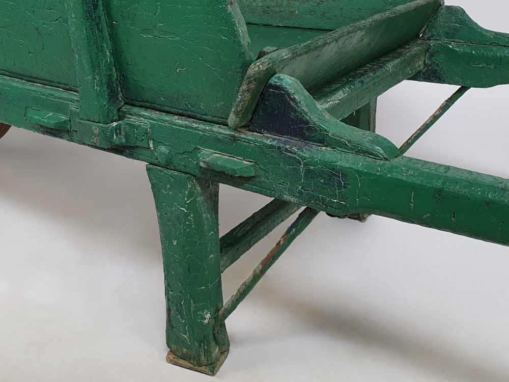 Antique garden wheelbarrow in original green paint