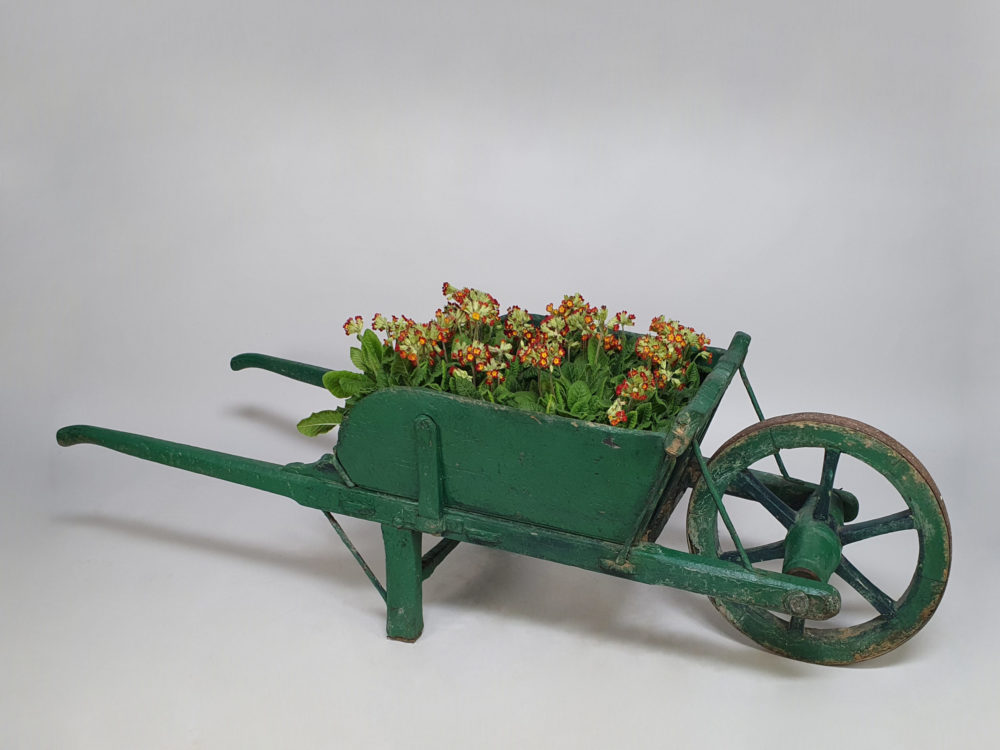 Antique garden wheelbarrow in original green paint