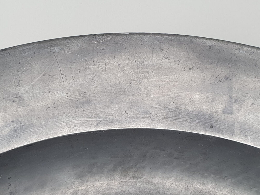 A large antique Georgian 18th century pewter Charger with and beaten detailing