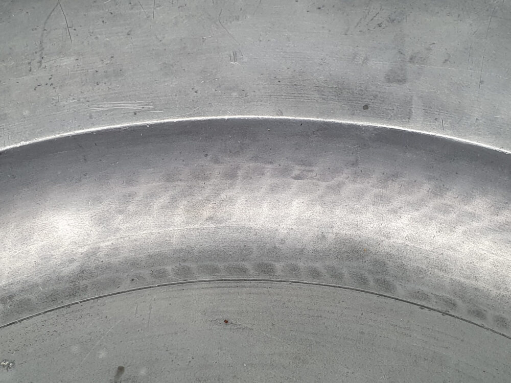 A large antique Georgian 18th century pewter Charger with and beaten detailing