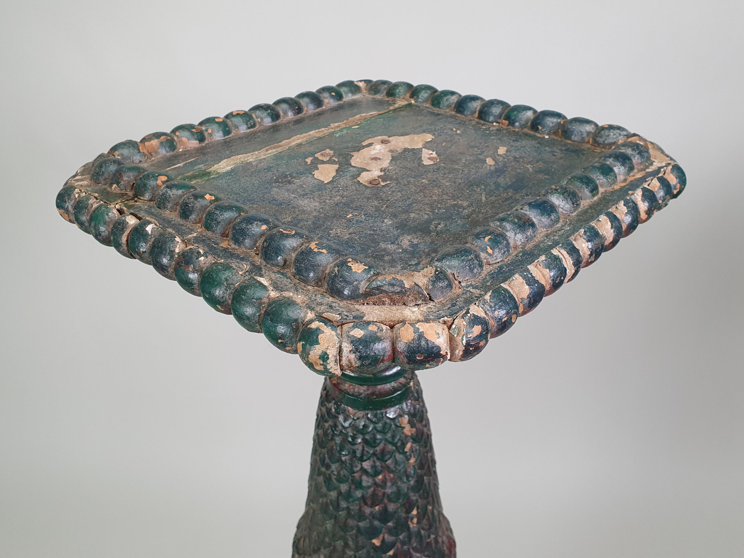 A pair of decorative antique Torchères in original green paint