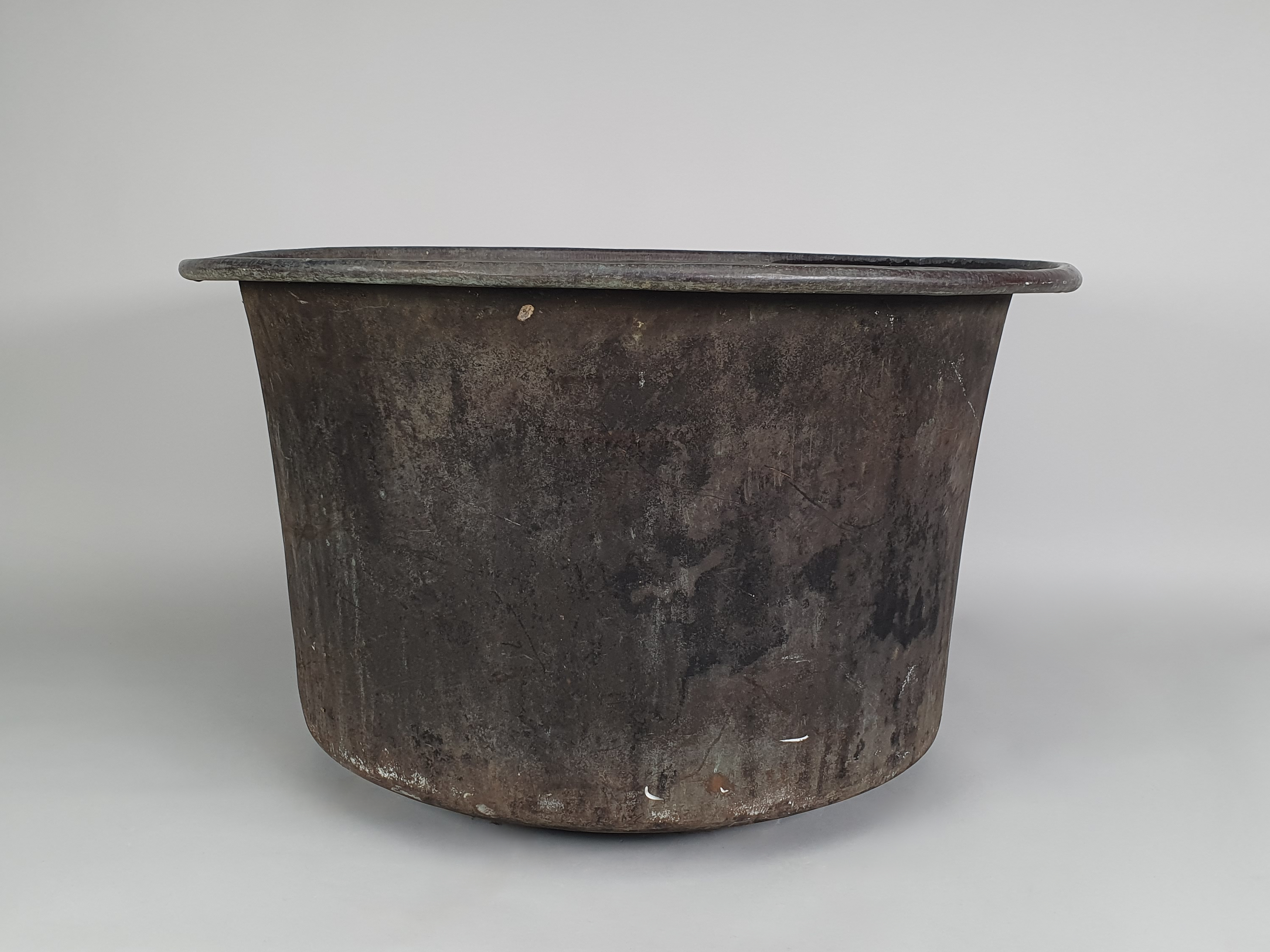 A pair of large garden antique copper planters wide shot