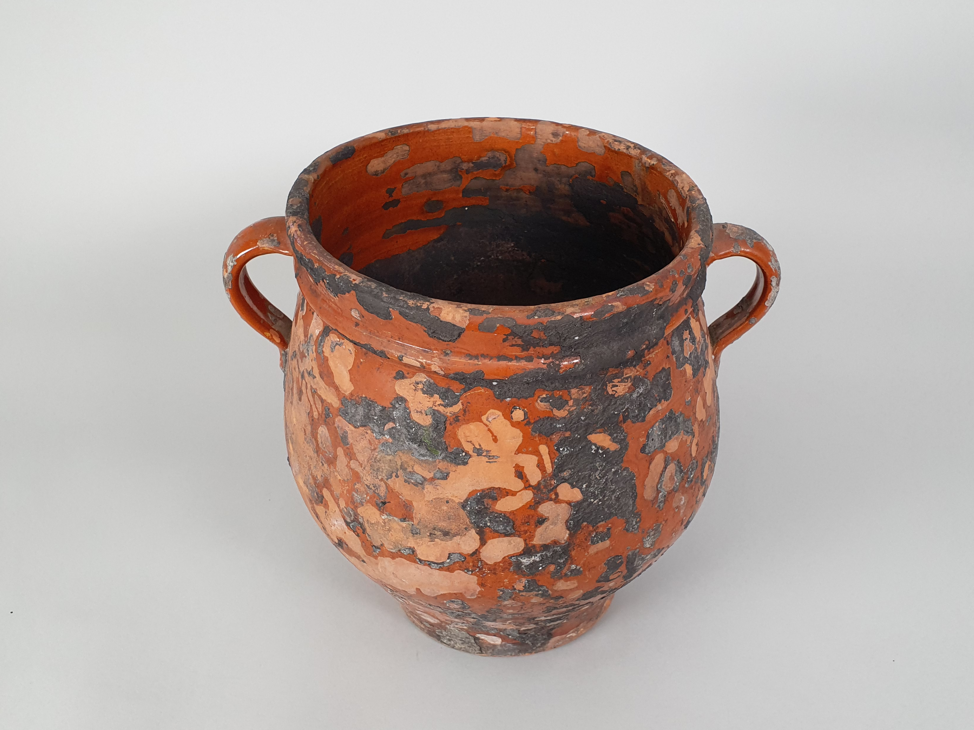 antique rustic pottery earthenware pot at an angle