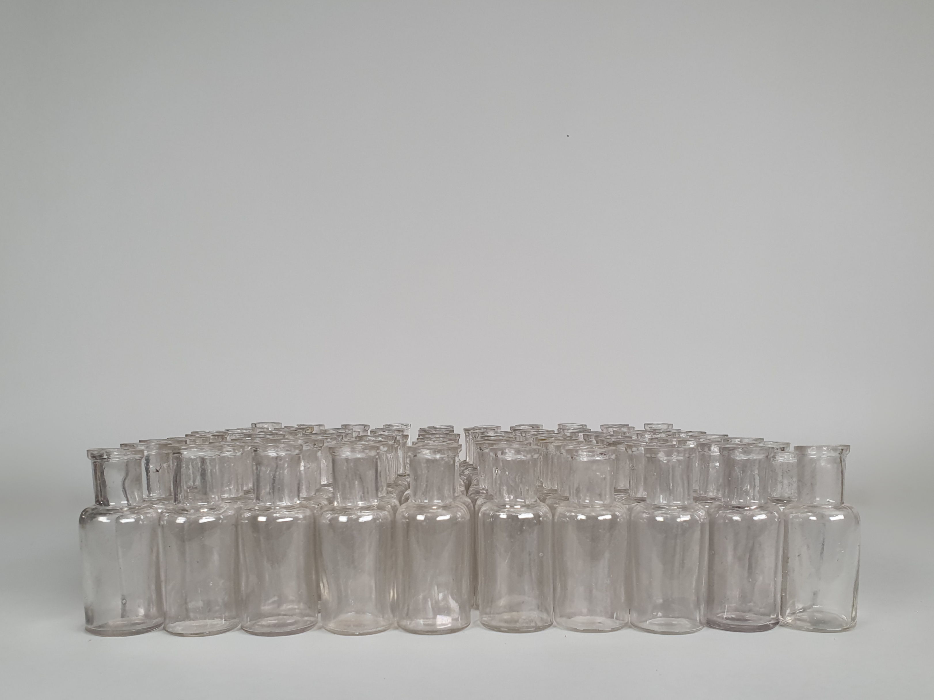 100 antique glass apothecary bottles in profile