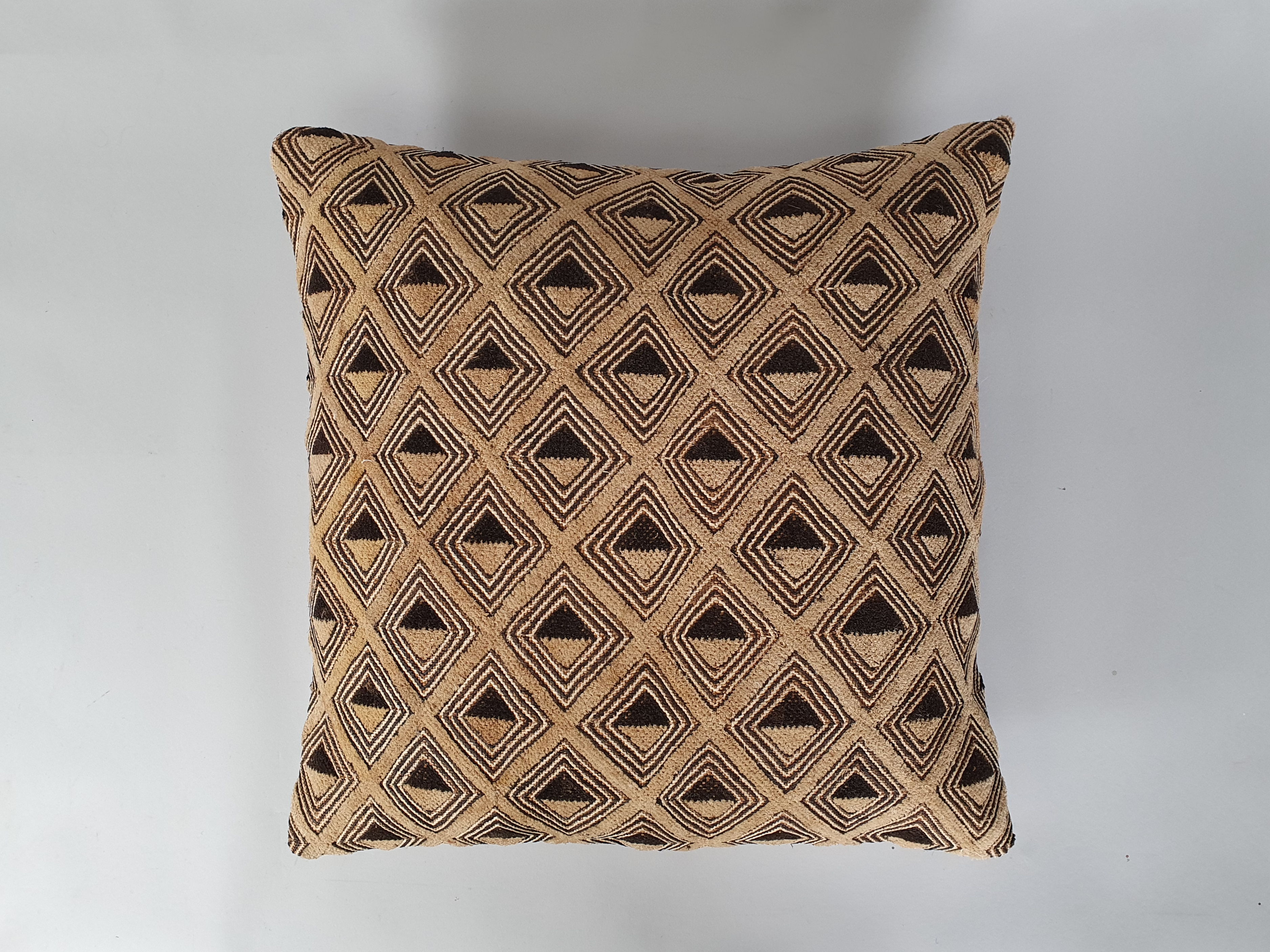 kuba cloth antique cushion wide shot