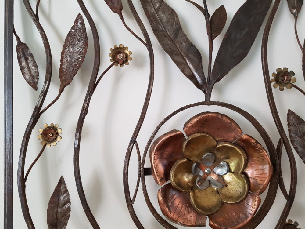 Mid century antique wrought iron sculpture with a copper Flower